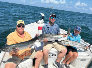people with fish they caught at off the hook charters 9